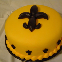 Black And Gold Made for a very special celebration - New Orleans Saints in the Super Bowl!! Cake covered in golden yellow fondant. Border piped with...