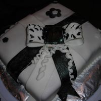 My First Decorated Cake Black and white present with a bow. It was made out of fondant.