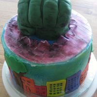 Hulk We molded Hulk hand from rice treats, covered in fondant, wanted to get a more cartoontype finish so we did the buildings all around the...