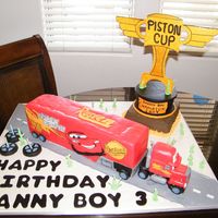 Mack Truck Mack truck is WASC with raspberry buttercream covered in MMF. Piston Cup Trophy cake 6" cake same as cake, bottom layer WASC with...