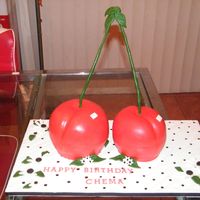 3D Cherry Cake 6" Wasc and 5" cakes carved to resemble 2 cherries on a stem. Covered in MMF and filled with strawberry buttercream