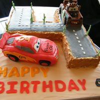 Lightning Mcqueen, Tow Mater, Cars Cake WASC cake with strawberry buttercream. Lightning McQueen covered with fondant and I used fondant accents on other cakes.