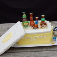 Father's Day Beer Bottle Cooler Cake Father's Day 2009 Cake - Sugar Beer Bottles in Cooler. The bottles and ice are made from sugar/corn syrup, the lid is chocolate...