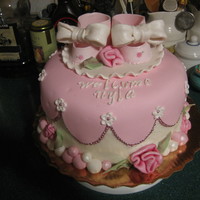 Baby Shower Cake 3 Layer Lemon cake with white Chocolate buttercream icingiced with buttercream and fondant with fondant and gumpaste decorations.