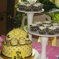 Chanel Baby Shower Cake Chanel cake with little baby bag and baby shoes. Cake is flavorful pound with buttercream filling and covered in Duff fondant.