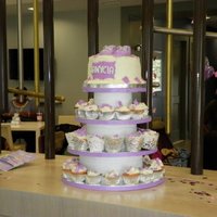 Baby Shower Cupcake Tower Assorted cupcakes decorated with chocolate accents.