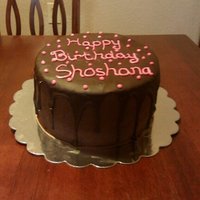 Shoshana's Cake 4 layer dark chocolate cake with dark chocolate ganache and a semi-sweet chocolate drip.