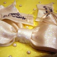 Bow_Cake_2.jpg This sheet cake is topped with a fondant/gumpaste blend bow that I painted with a mixture of pearl dust, snowflake mystical dust, and vodka...