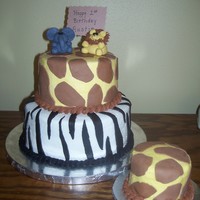 Safari Birthday Cake 1st birthday cake for a little boy. First attempt at fondant animals, my internet went out while I was making them so didn't have a...