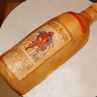 Captian Morgan's Bottle 3-D Captian Morgan's Spiced Rum made out of carrot cake, covered with creamcheese icing and fondant. used air brush to spray gold on...