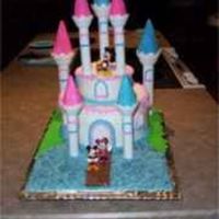 Mickey & Minnie Castle Cake Cake is white with raspberry filling. Bottom is triple layer 10 inch and top is double layer 6 inch. Frosted in BC.