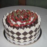 Chocolate Checkerboard 3 layer, 10" round covered with molded chocolate and white chocolate squares, dipped strawberries on top