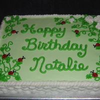 Ladybugs Buttercream ladybugs and royal icing blossoms