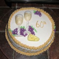 60Th Birthday Beer spice cake covered in BC. I used fondant for the wine glasses, cheese and grapes and luster dust. Thanks to four321 for the design!...
