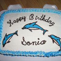Dolphin Birthday Chocolate and vanilla cake with custard filling and BC. Dolphins made of hardened chocolate outline and RI.