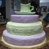 Teacup Cake Gumpaste teacup w/RI details. Three different cake flavors all covered in MMF with RI details.