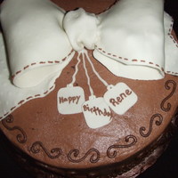 Birthday Bow White WASC with Chocolate BC. Fondant bow with tylose mixed in. I forgot to add the threading to the inside of the bow. I just realized it...