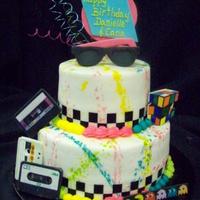 80's Theme This cake was for an 80's themed birthday party. Everything is edible except for the curly que wires on top. We used edible images for...