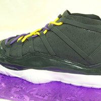 3D Tennis Shoe Cake is covered with fondant; shine was achieved by painting the fondant with edible lacquer.
