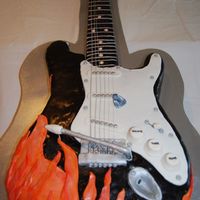 Fender Guitar Cake Full sized Fender guitar cake with flames. Neck is made with rice krispy. All covered in MMF. Real guitar strings.