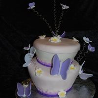 Butterflies In Flight Topsy Turvy Cake with Butterflies and Daisies. Done in MM Fondant. This was for a baby shower and matched the invites.