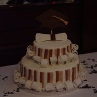 Tiered College Grad Cake Fondant Cake. Cake is topped by a fondant diploma and grad cap. Design is from Wilton.