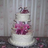 25Th Anniversary Fresh Flowers on 2 tier cake w/ pillars. Very simple design. I thought those drop strings would be the death of me!!! They kept breaking &...