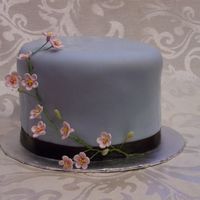 Blue Fondant With Cherry Blossoms Brown ribbon Border. 1st attempt at gp flowers!