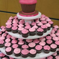 Pink & Brown Cupcakes This is a 3-tiered cupcake stand with 280 chocolate cupcakes for a pink and brown wedding. A large fondant-covered cupcake-shaped cake on...