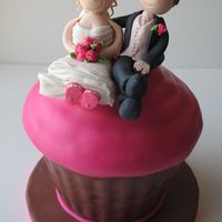 Cupcake Wedding Cake Large cupcake wedding cake with gumpaste bride and groom topper. This cake sat on top of a 3-tiered cupcake stand for a pink and brown...