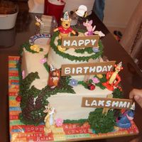 Pooh Cake My First Tiered cake (except for wilton course III where I used the pillars). The toys kept on falling and I couldn't smooth the icing...