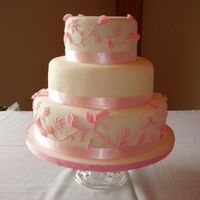 Pink Floral Wedding Cake This cake was a banana cake with chocolate ganache filling. Fondant with royal icing and fondant details.