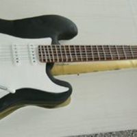 Fender Guitar Chocolate cake covered in chocolate fondant (coloured black) fret made from fondant.