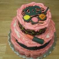 Chanel & Make Up Cake 2 tier with Ace of Cakes paper around both tiers. Accents made from fondant.