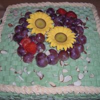 Mother's Day Fruit and Flowers Basket. The sunflowers are in gum paste and place some grapes too. The color is avocado and use the tips 48 and 18.This...