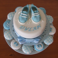 Dylan Baby Topper & Cupcakes Foam Topper made for display. Boots are gumpaste using pattern from CC. Cupcakes vanilla with fondant tops in various styles.