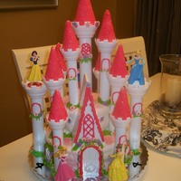 Princess Castle Cake Cake covered in MMF with fondant flowers and royal icing leaves.