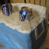 Ice Chest With Beers Stacked rectanguler layers of white cake, covered in blue buttercream (white on top). Fondant handles and frosted rice krispie treat lid....