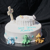 Baptism Cake Yellow cake with chocolate chip cookie dough buttercream filling iced in buttercream. Fondant animals and cradle with baby. White chocolate...