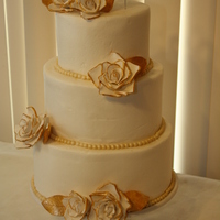 50Th Anniversary Cake 3 tier fondant covered with gold accents and sugar roses