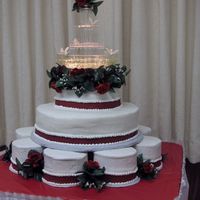 Marlana's Rose Fountain Roses surrounding stacked tiers and fountain used for topper. Deep rose fondant border on all layers trimmed top and bottom with...