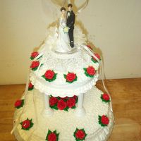 Karen's Cake Single layer (that's what she wanted) tiered wedding cake. Buttercream roses and cornelis lace piped on the bottom tier with a tip 3....