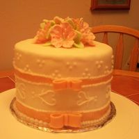 Wedding Cake Top Top tier for a wedding cake. Covered in fondant with pink fondant ribbons and pink royal icing petunias.