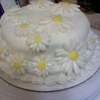 First Fondant Cake my first fondant cake with fondant daisies. used pearl dust on the daisies. i just finished course 1 i tried this at home on my own.