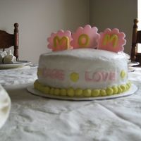 Mother's Day Project Double layer 8 inch white cake with cookies-n-cream filling. Iced in buttercream with fondant accents. Words around the cake describe a...