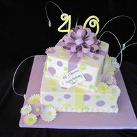 Fabulous Forty An 8" and 12" Vanilla cake with buttercream icing, fondant accents, gum paste gerber daisies, bow, gift card and numbers. A bit...