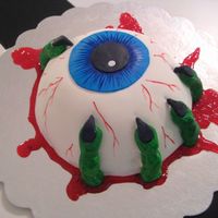 Bloody Eyeball Cake My husband and I made this cake for a halloween contest, it's a chocolate cake with vanilla BC and covered in MMF.