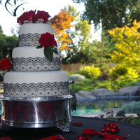 Black Lace Wedding White fondant, black lace and red roses.