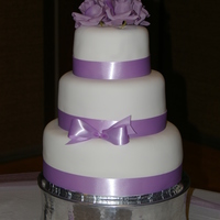 Simply Lavender White fondant over Vanilla cake with cheesecake filling.