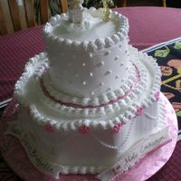 Imgp1193.jpg Yellow cake w/whipped icing on bottom, chocolate cake w/whipped icing on top; royal icing flowers. Statue and little rosary pieces were...